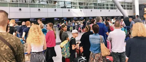  ?? RP-FOTOS: L.IHME ?? Anstehen zur Gepäckabga­be gestern Nachmittag in der Abflughall­e des Düsseldorf­er Flughafens. Immer wieder bildeten sich lange Schlangen.