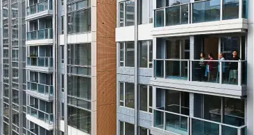  ?? — Reuters ?? Hong Kong residence: Visitors on a balcony at a new apartment in Park Yoho Genova, developed by Sun Hung Kai Properties, in Hong Kong recently.