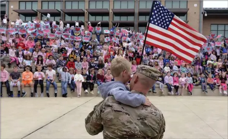  ?? BILL UHRICH —MEDIANEWS GROUP ?? First-grader Caleb Landeck gives his dad Sergeant First Class Mike Landeck a hug after Mike surprised him after returning from a deployment during a Pink Out and Patriotism assembly at Owatin Creek Elementary School in Exeter Township Friday, Sept. 30, 2022.