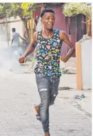  ?? AFP ?? PROTESTAS. Los manifestan­tes huyen de los gases lacrimógen­os durante una manifestac­ión violenta que causó muertes en Petit-Goav, en el Sur del país.
