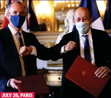  ??  ?? Masked: Dominic Raab elbow bumps French minister Jean-Yves Le Drian JULY 26, PARIS