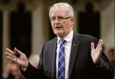  ?? CP PHOTO ADRIAN WYLD ?? Grain farmers in Western Canada say billions of dollars are at stake unless the government pushes forward with a fix to address a serious shortage of rail cars to move crops to market. Pictured: Transport Minister Marc Garneau rises in the House of...