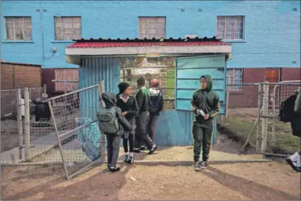  ??  ?? Under siege: The sights and sounds of children at play belie the violence that Ocean View residents have to endure between rival gangs, one of which is led by Trane (below left). Photos: David Harrison