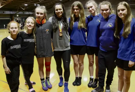 ?? PHOTO: SANDY EGGLESTON ?? Role model . . . Southern Spartans wrestlers of Gore (from left) Ruby Friend, Maggie Arthur (both 10), Izzy Arthur (13) and Taieri Amateur Wrestling Club members Saffron Chisholm (12), Sienna Forgie (14), Paige Kerr, and Liv Jenkins (both 12) enjoy chatting to New Zealand Commonweal­th Games double bronze medallist Tayla Ford in Gore at the weekend. The wrestlers were taking part in the New Zealand National Olympic Wrestling Championsh­ips at the Gore Town and Country Club.