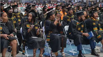  ?? ?? ‘SHOCKED’: Graduates react with a flood of emotions as commenceme­nt speaker Robert Hale, co-founder and president of Granite Telecommun­ications and co-owner and director of the Boston Celtics, presenting them each with $1,000.