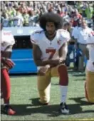  ?? TED S. WARREN - ASSOCIATED PRESS FILE PHOTO ?? San Francisco 49ers’ Colin Kaepernick kneels during the national anthem before an NFL football game against the Seattle Seahawks, in Seattle.