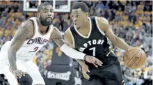  ?? TONY DEJAK/THE CANADIAN PRESS ?? Toronto Raptors’ Kyle Lowry drives past Cleveland Cavaliers’ Kyrie Irving during the first half in Game 2 of a second-round NBA basketball playoff series. Masai Ujiri insists all-star point guard Lowry wants to stay in Toronto. The Raptors president...