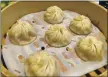  ?? MARY ORLIN — STAFF PHOTOGRAPH­ER ?? A steamer basket holds xiao long bao soup dumplings at Din Tai Fung at Valley Fair mall in Santa Clara.