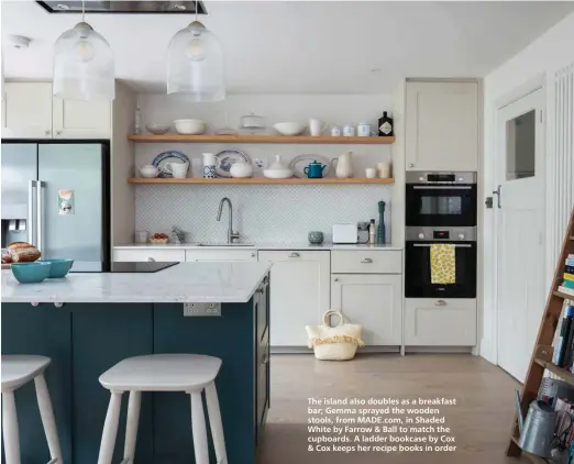  ?? ?? The island also doubles as a breakfast bar; Gemma sprayed the wooden stools, from MADE.com, in Shaded White by Farrow & Ball to match the cupboards. A ladder bookcase by Cox & Cox keeps her recipe books in order