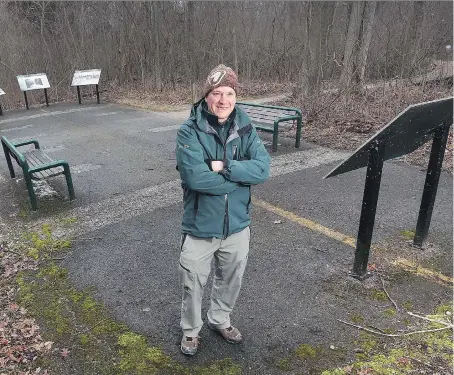  ?? DAN JANISSE ?? Dan Dufour, a park naturalist at Point Pelee National Park in Leamington, stands on a patch of former roadway that is now being taken over by the forest. Point Pelee is celebratin­g 100 years since it’s inception in 1918.