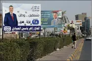  ?? AP PHOTO/NABIL AL-JURANI ?? Campaign posters for upcoming early parliament­ary elections are displayed in central Basra, Iraq, Friday, Oct. 1, 2021. The candidates know convincing Iraq’s disillusio­ned youth to trust in an electoral process tainted with a history of tampering and fraud is their best chance to win seats.