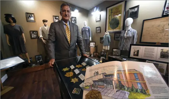  ?? BILL UHRICH — MEDIANEWS GROUP ?? State Rep. Mark Gillen, director of the World War II Museum in Mohnton, in the Holocaust section of the museum with an artist’s rendering of the proposed wing that would house an expanded Holocaust display.