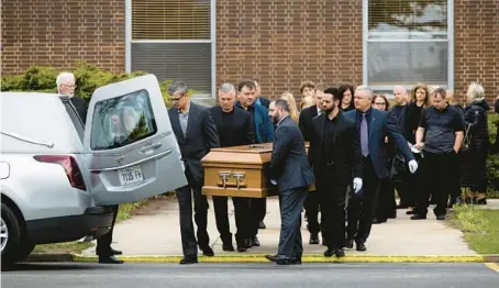  ?? VINCENT ALBAN/CHICAGO TRIBUNE ?? Pallbearer­s carry the casket of Naperville Central High School freshman Aleksas “Alex” Beiga during his funeral procession Friday at Blessed Jurgis Matulaitis Lithuanian Catholic Mission in Lemont.