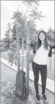  ?? COURTEY PHOTO ?? Karen Ma, 17, stands next to one of the Chinese pistache trees she’s helped plant around Cupertino.