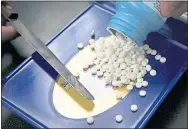  ?? THE ASSOCIATED PRESS ?? Some prescripti­ons can be more expensive with insurance. Pharmacist­s also may be prevented from offering a better deal.