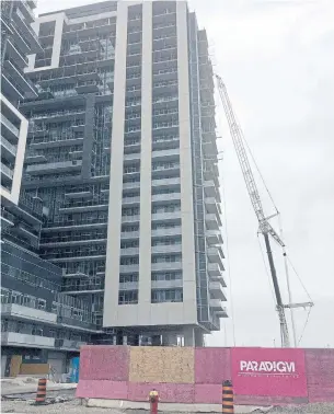  ?? TESS KALINOWSKI/TORONTO STAR ?? The massive Paradigm condo complex near the Burlington GO station is being built where residents and some politician­s say it belongs: north of the city's downtown.