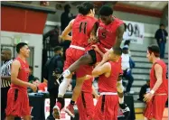  ??  ?? Portervill­e College Pirates celebrate after defeating Oxnard College, 99- 95 Wednesday.