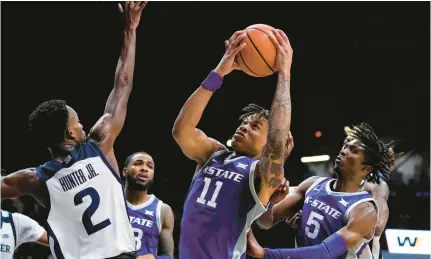  ?? MICHAEL CONROY/AP ?? Kansas State forward and former Norview High star Keyontae Johnson grabs a rebound against Butler during a Nov. 30 game. The Wildcats are one of five Big 12 teams ranked in the Associated Press Top 25.