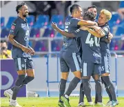  ?? ?? Buriram’s Theerathon Bunmathan, right, celebrates his goal with teammates.