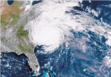  ?? NOAA/ASSOCIATED PRESS ?? This satellite image shows Hurricane Florence on the eastern coast of the United States on Friday. The 400-mile-wide storm pounded the coast with torrential downpours and surging seas.