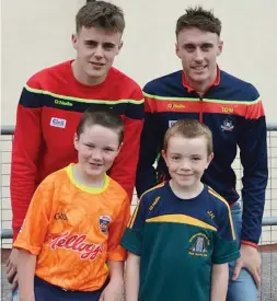  ??  ?? Cork Hurling Team members Daragh Fitzgibbon and Tim O’ Mahony, with Diarmuid Fleming and Jack Hennessy from Liscarroll National School.