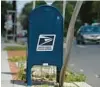  ?? NICHOLAS KAMM/GETTY-AFP ?? A United States Postal Service mailbox sits in front of a post office in Washington, D.C., similar to the mailbox on Datura Street in West Palm Beach from which thieves fished checks written by the Palm Beach County Transporta­tion Planning Agency.