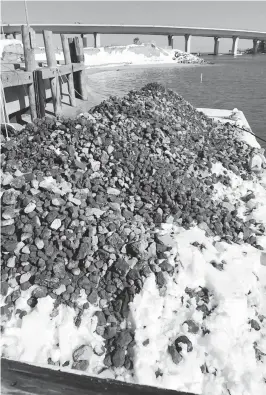  ?? COURTESY PHOTO ?? Tons of crushed concrete on a barge will be used to form an oyster reef in the Lynnhaven River.