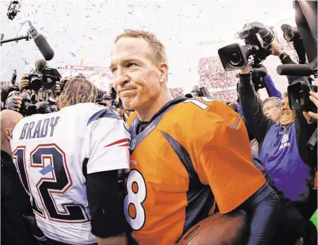  ?? Ezra Shaw / Getty Images ?? Peyton Manning was the last quarterbac­k smiling Sunday after he and the Patriots’ Tom Brady faced off for the 17th time in their careers.