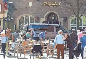  ?? STEPHAN R./DPA VIA AP ?? People stand in front of a restaurant in Muenster, Germany, on Saturday after a vehicle crashed into a crowd killing at least two people and injuring 20 others.