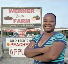  ?? TIFFANY MAYER/SPECIAL TO POSTMEDIA NEWS ?? Kashima Woodham, 33, is a seasonal agricultur­al worker from Montego Bay, Jamaica. She spends four months a year here minding a Niagara-on-the-Lake fruit stand.