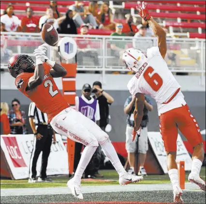  ?? Erik Verduzco Las Vegas Review-Journal @Erik_Verduzco ?? UNLV wide receiver Mekhi Stevenson drops the ball in the end zone against New Mexico safety A.J. Greeley in the fourth quarter Saturday at Sam Boyd Stadium. The Rebels lost 50-14.