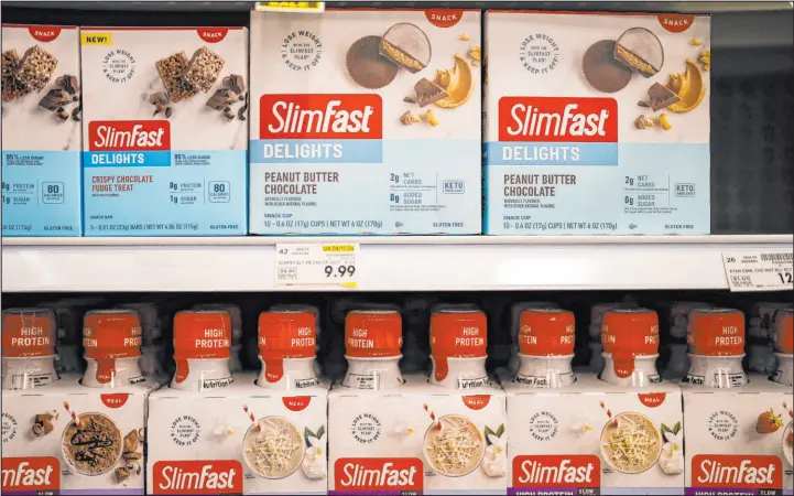  ?? Mike Stewart The Associated Press ?? Sales of Slimfast at supermarke­ts have dropped as people turn to weight loss drugs and retailers cut shelf space for diet products, the brand’s parent company, Glanbia, said.