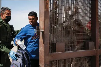  ?? ?? A border patrol agent searches a group of migrants in El Paso, Texas, on Wednesday. Photograph: Justin Hamel/Reuters