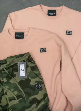  ??  ?? The new David Alan ready-to-wear clothing line includes crew necks and camo joggers.