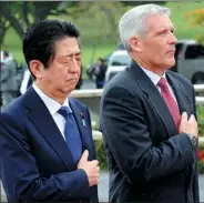  ?? HUGH GENTRY / REUTERS ?? Japanese Prime Minister Shinzo Abe and James Horton, director of the US National Memorial of the Pacific, observe a moment of silence on Monday.