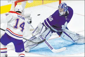  ?? Frank Gunn The Associated Press ?? Canadiens center Nick Suzuki scores against Maple Leafs goaltender Jack Campbell at 59 seconds of overtime Thursday in Montreal’s 4-3 win at Scotiabank Arena.