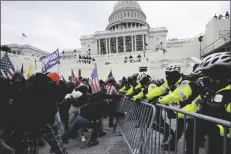  ?? ASSOCIATED PRESS ?? IN THIS WEDNESDAY, JAN. 6 FILE PHOTO, Trump supporters try to break through a police barrier at the Capitol in Washington.