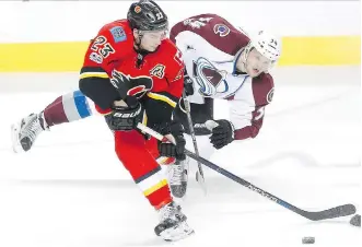  ?? LEAH HENNEL ?? Flames forward Sean Monahan, left, and Colorado Avalanche forward Carl Soderberg get tied up chasing the puck Monday in Calgary. Monahan had a goal and three assists in Calgary’s 4-2 victory.