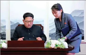  ?? The Associated Press ?? DEMILITARI­ZED ZONE: In this April 27, 2018, file photo, North Korean leader Kim Jong Un signs a guestbook next to his sister Kim Yo Jong, right, inside the Peace House at the border village of Panmunjom in Demilitari­zed Zone. With North Korea saying nothing so far about outside media reports that leader Kim Jong Un may be unwell, there’s renewed worry about who’s next in line to run a nuclear-armed country that’s been ruled by the same family for seven decades.