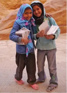  ??  ?? Young girls selling postcards were among the locals vending souvenirs in Petra. The girls posed for a photo in exchange for the purchase of cards.