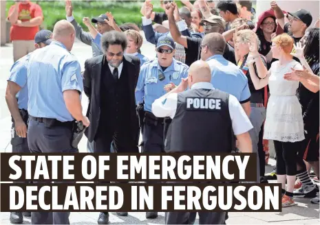  ??  ?? JEFF ROBERSON, AP
Activist Cornel West is arrested by St. Louis Police during a protest outside the Thomas F. Eagleton Courthouse on Monday.