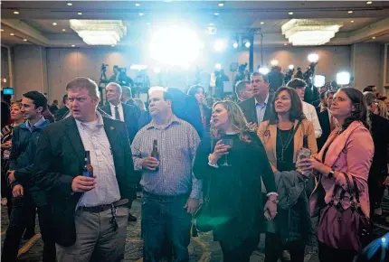  ?? ADAM CAIRNS/USA TODAY NETWORK ?? Republican supporters gather in front of the TV screens to watch midterm election results roll in at an election night party for statewide GOP candidates at the Renaissanc­e Hotel in downtown Columbus, Ohio.