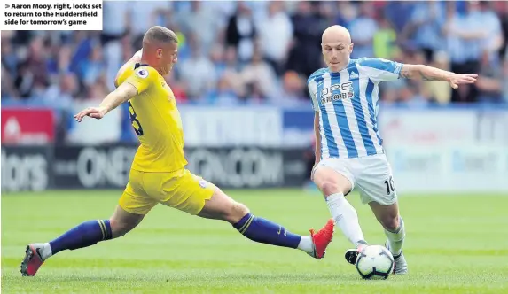 ??  ?? &gt; Aaron Mooy, right, looks set to return to the Huddersfie­ld side for tomorrow’s game