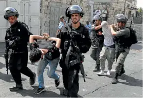  ??  ?? Israeli security forces arrest Palestinia­n men following clashes outside the Old City in Jerusalem yesterday.