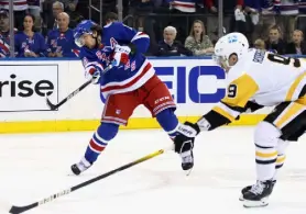  ?? Bruce Bennett, Getty Images ?? Rangers Artemi Panarin scores the series-winning overtime goal against the Penguins on Sunday at Madison Square Garden in New York.