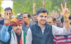  ?? PTI PHOTO ?? Rajasthan Congress chief Sachin Pilot and Congress candidate Raghu Sharma (left) flash victory sign after the latter's bypoll victory in Ajmer on Thursday.