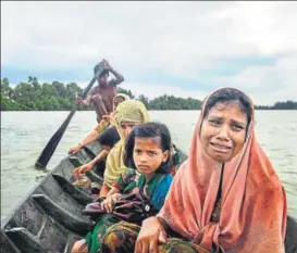  ?? ADAM DEAN/NYT ?? Tasmida (front), an 18yearold Rohingya refugee who spent eight days walking and hiding to reach the border, left Myanmar by crossing the Naf River near Palong Khali in Bangladesh on September 4. The UN has said up to 400,000 Rohingya, more than half...