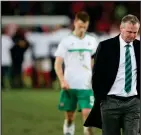  ??  ?? Michael O’Neill cuts a dejected figure after his side lost their two-legged World Cup play-off against Switzerlan­d