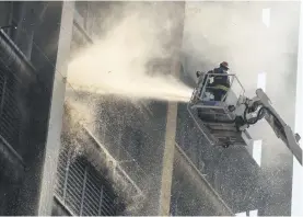  ?? Picture: Neil McCartney ?? DANGER ZONE. Firefighte­rs battle the fire in the department of health building in the Joburg CBD earlier this month. Three firefighte­rs died in the blaze.