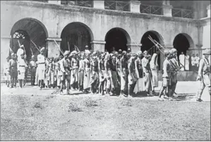  ?? GETTY IMAGE ?? A 1925 photo of Mappila prisoners going to trial in Calicut for agitating against the British. In 192122, during a rebellion against the British as well as the feudal class – mostly Hindus – as many as 2,400 Mappilas were killed and nearly 40,000...